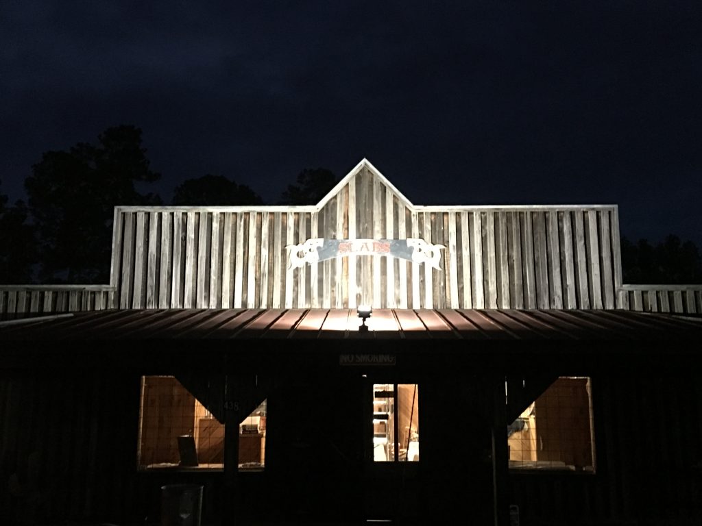 Slabs Lake City wood sign hanging on building at #SlabsLakeCitySC wood handles stainless sign #Slabs #Barbecue #pig #BBQ #pig #pork #slabsSC