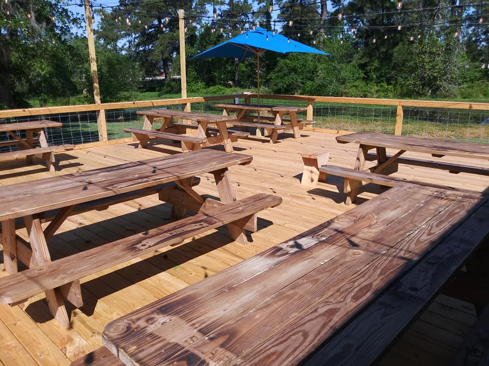Slabs BBQ Restaurant #cookedonwood #brisket #ribs #pulled pork. Outside seating Deck  #romanticdining #lakefrontdining. Sit underneath the stars. Seating under the old oak trees. #Barbeque #lakesidedining #wooddeck #outsideseating #LakeCityBBQ #lakeCitySCdining #romanticdiningSC