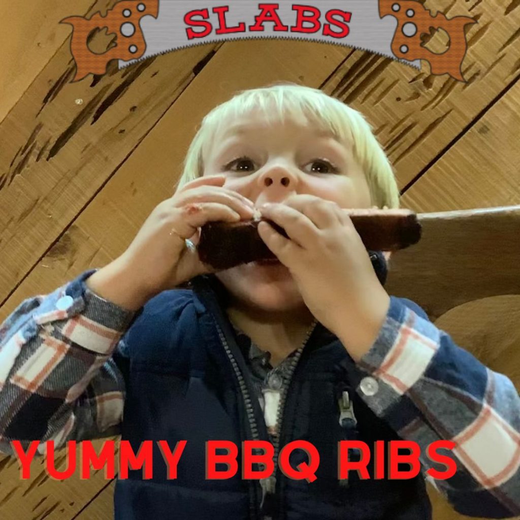 Cute little boy model eating ribs at Slabs
